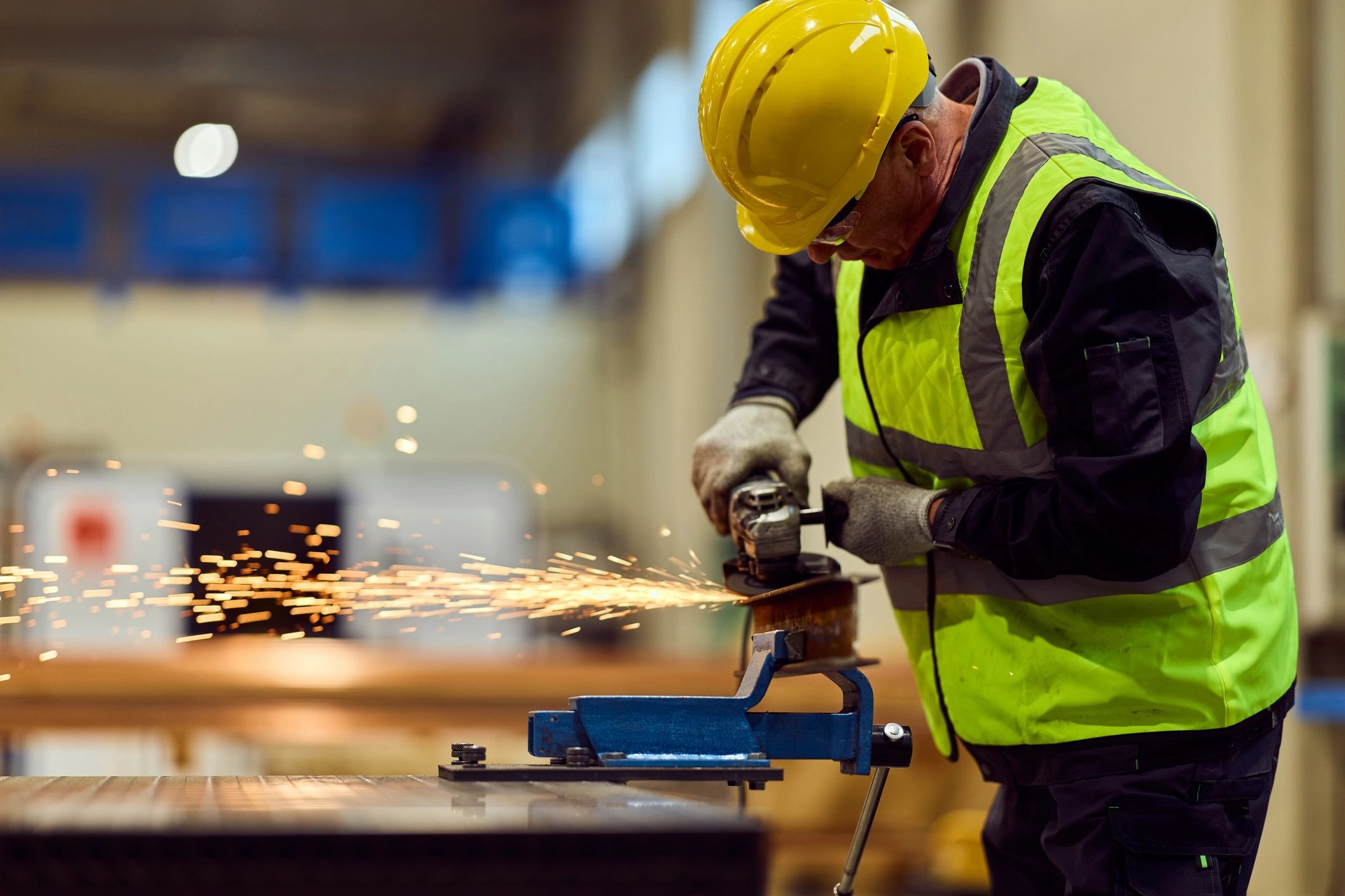 Welder performing precision metal work in a fabrication workshop